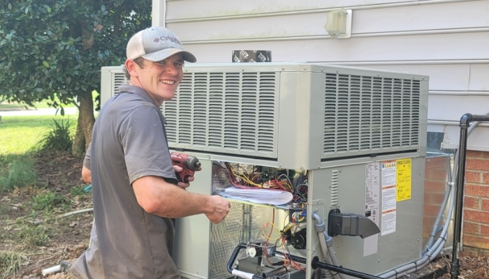 Smiling Technician Repairing Ac Unit 1